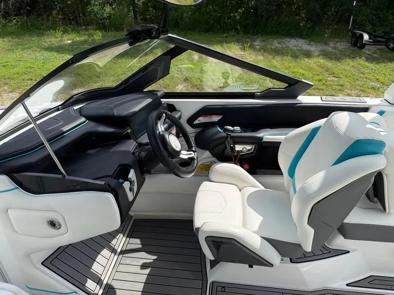 Slide: The Image of Interior of 2020 Nautique Super Air Nautique G21 boat with modern dashboard and seating. - 11