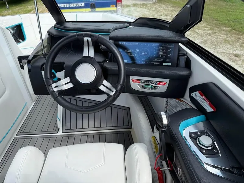 Slide: The Image of 2020 Nautique Super Air Nautique G21 dashboard with steering wheel and digital display. - 12