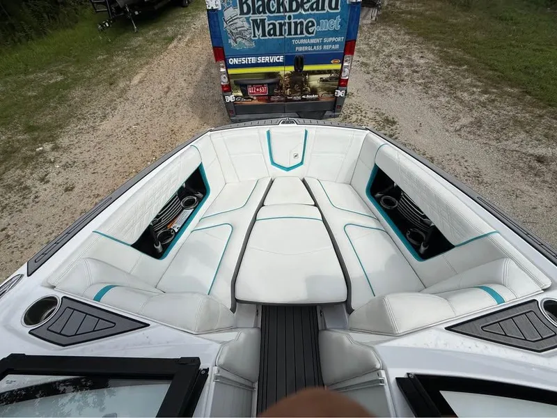 Slide: The Image of 2020 Nautique Super Air Nautique G21 boat interior with white seating and teal accents. - 14