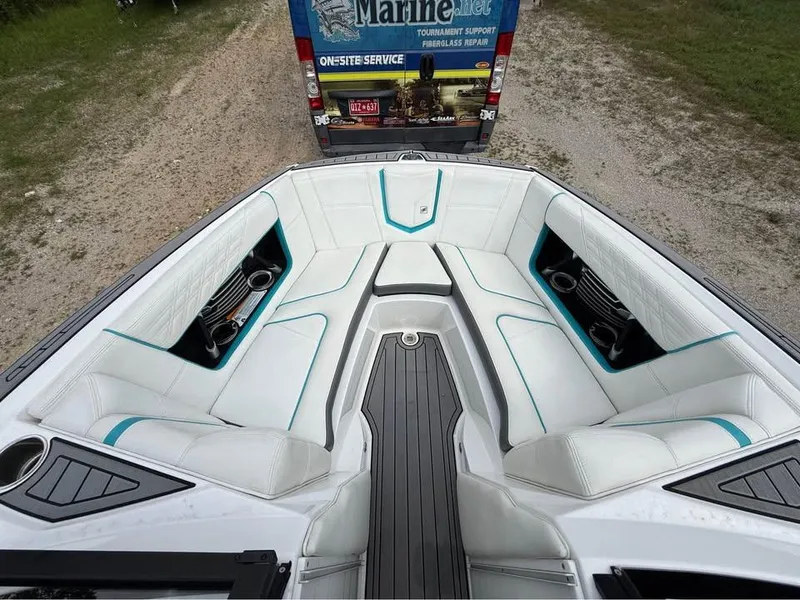 Slide: The Image of 2020 Nautique Super Air Nautique G21 boat interior with white seating and teal accents. - 15