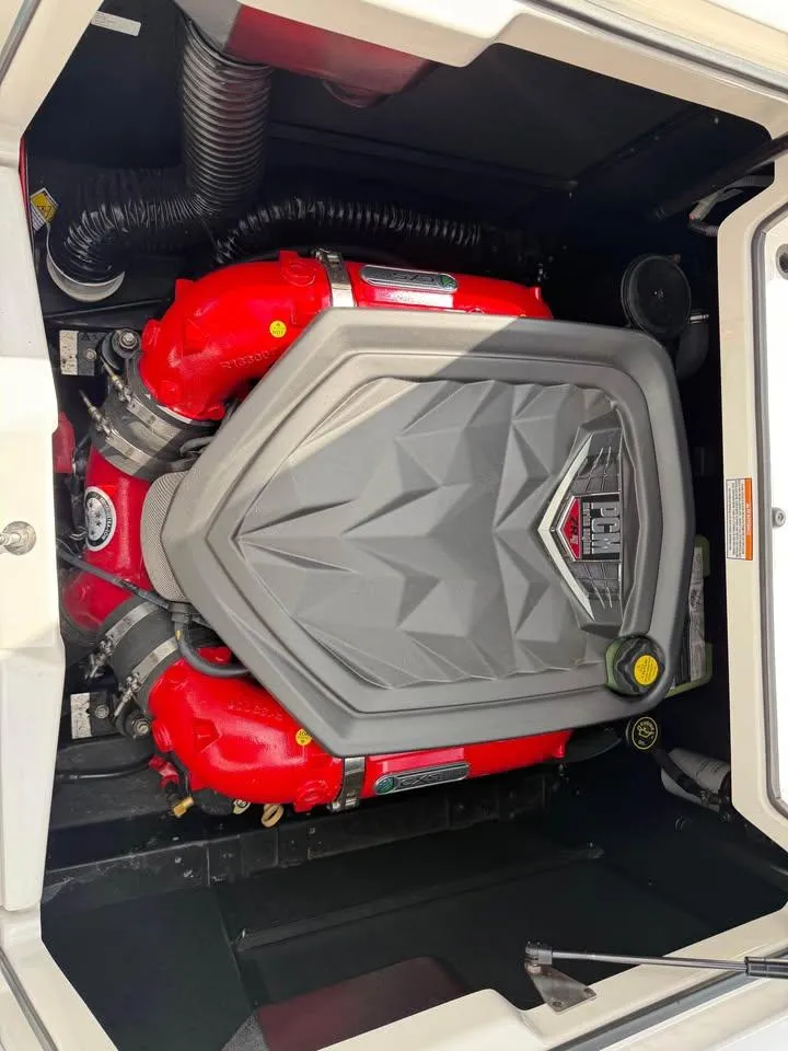 Slide: The Image of 2020 Nautique Super Air Nautique G21 engine with red components and gray cover. - 18