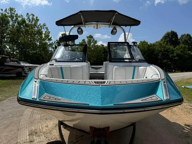Slide: The Image of 2020 Nautique Super Air Nautique G21 boat with teal exterior, parked outdoors. - 2