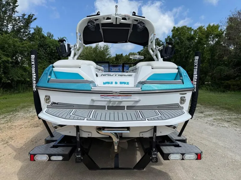 Slide: The Image of 2020 Nautique Super Air Nautique G21 boat, rear view, on a trailer, outdoors. - 6