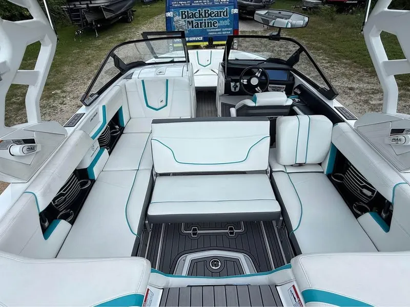 Slide: The Image of 2020 Nautique Super Air Nautique G21 interior with white and teal seating, steering wheel, and dashboard. - 9