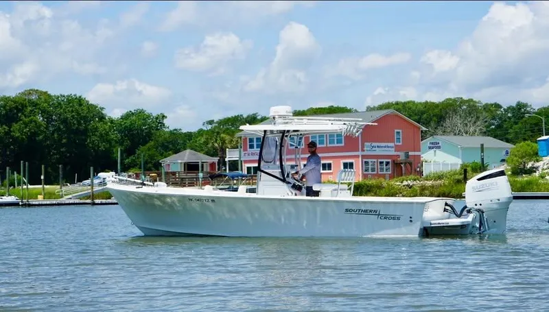 Slide: The Image of 2022 Southern Cross 25 boat on water near colorful waterfront buildings. - 0