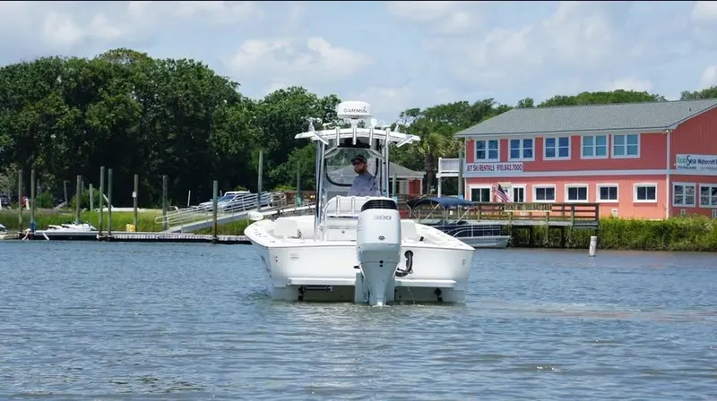 Slide: The Image of Southern Cross 25 boat on water near colorful waterfront building, 2022 model. - 1