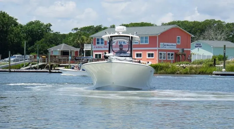 Slide: The Image of 2022 Southern Cross 25 boat cruising near waterfront buildings. - 3