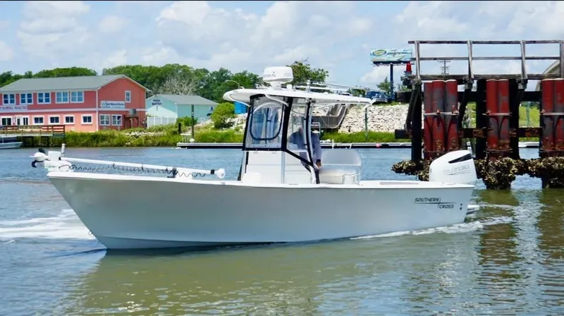 Slide: The Image of Southern Cross 25 boat cruising near colorful waterfront buildings, 2022 model. - 4