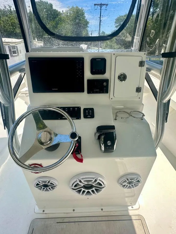 Slide: The Image of Control console of a 2022 Southern Cross 25 boat with steering wheel and electronics. - 5