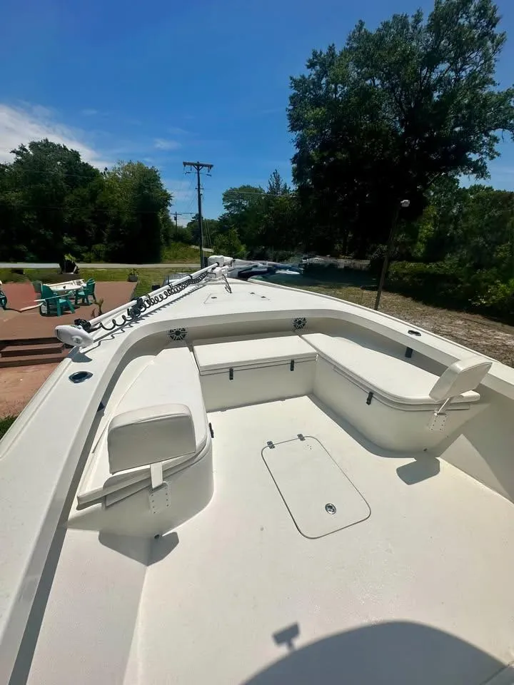 Slide: The Image of 2022 Southern Cross 25 boat with spacious seating, set outdoors under a clear blue sky. - 8