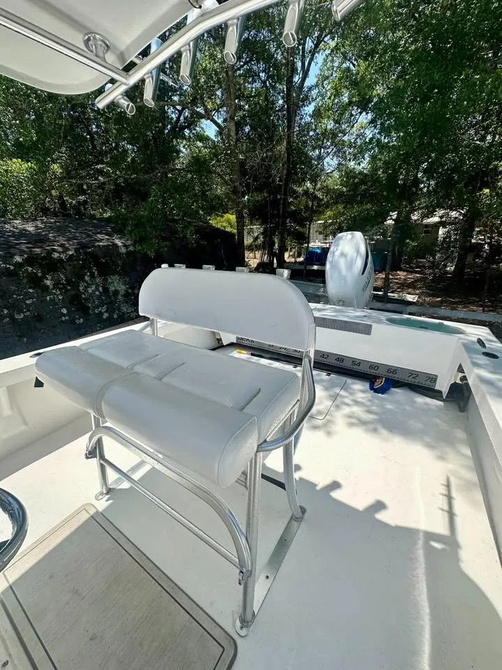 Slide: The Image of White seating on 2022 Southern Cross 25 boat, surrounded by trees. - 9