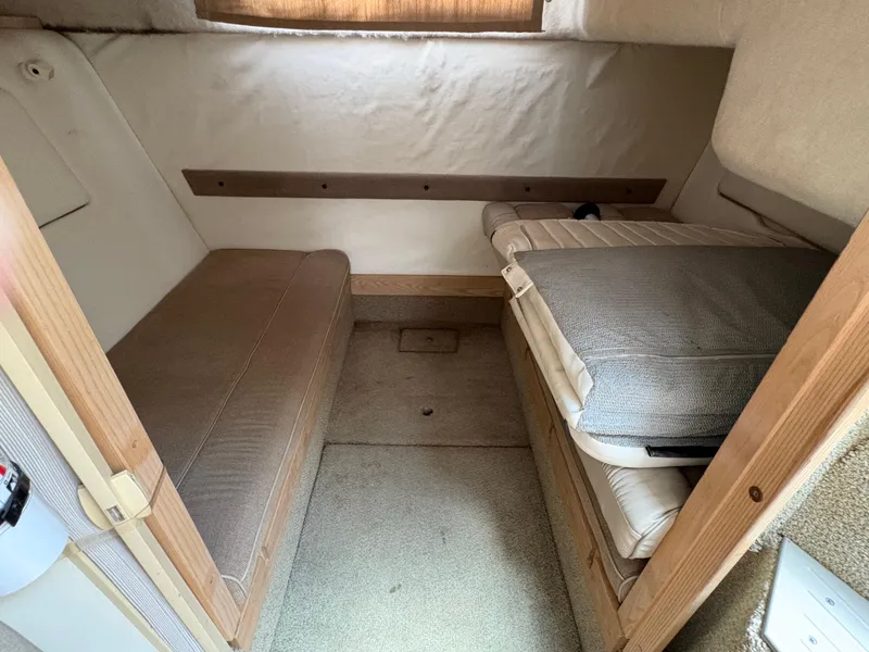 Slide: The Image of 1997 Maxum 3200 SCR cabin interior with beige seating and wooden accents. - 11