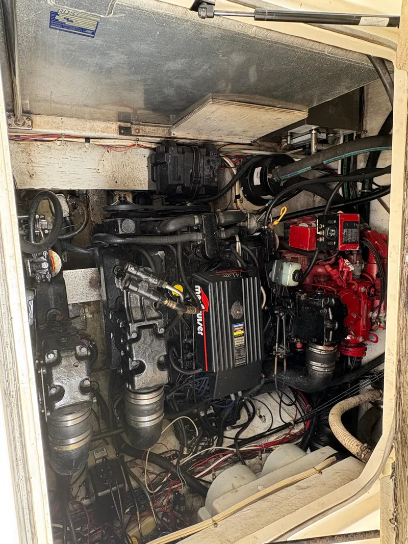 Slide: The Image of Engine compartment of a 1997 Maxum 3200 SCR boat, showcasing mechanical components. - 14