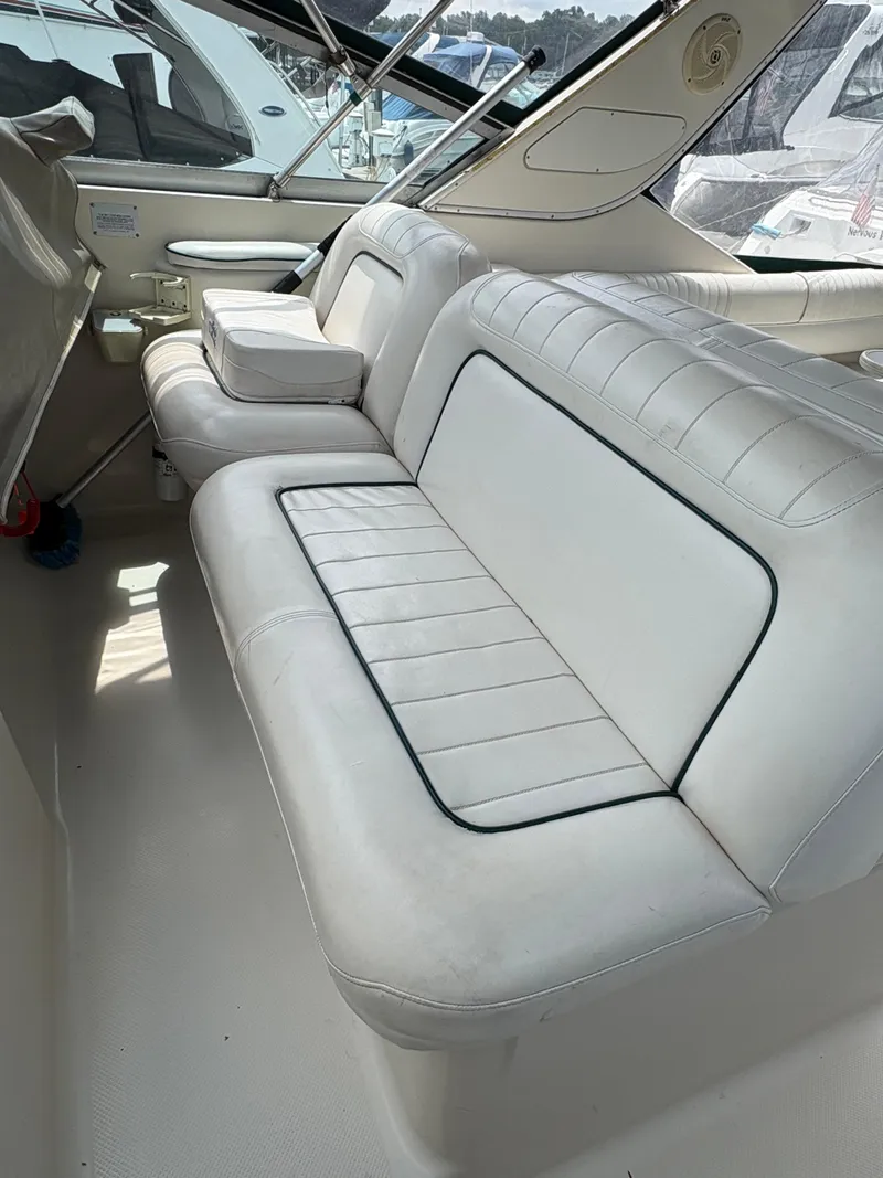 Slide: The Image of 1997 Maxum 3200 SCR boat interior with white leather seating and sleek design. - 16
