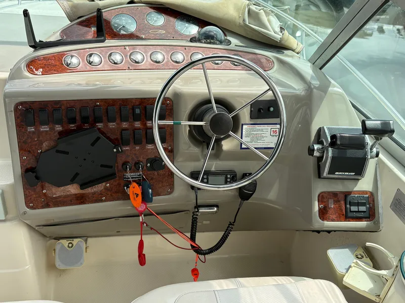 Slide: The Image of 1997 Maxum 3200 SCR boat dashboard with steering wheel and control panel. - 17