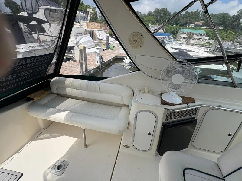 Slide: The Image of Interior of 1997 Maxum 3200 SCR yacht with seating, fan, and dock view. - 22