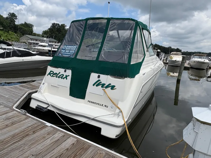 Slide: The Image of 1997 Maxum 3200 SCR boat docked, green canopy, "Relax Inn" text, Pennsville, NJ. - 3