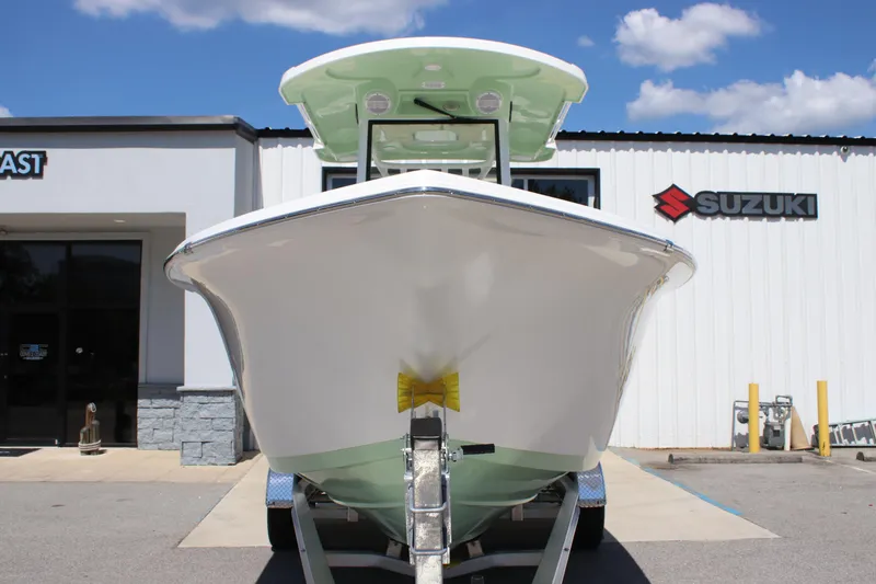 Slide: The Image of 2026 Sea Pro 245 Sandbar boat on trailer outside Suzuki dealership. - 12
