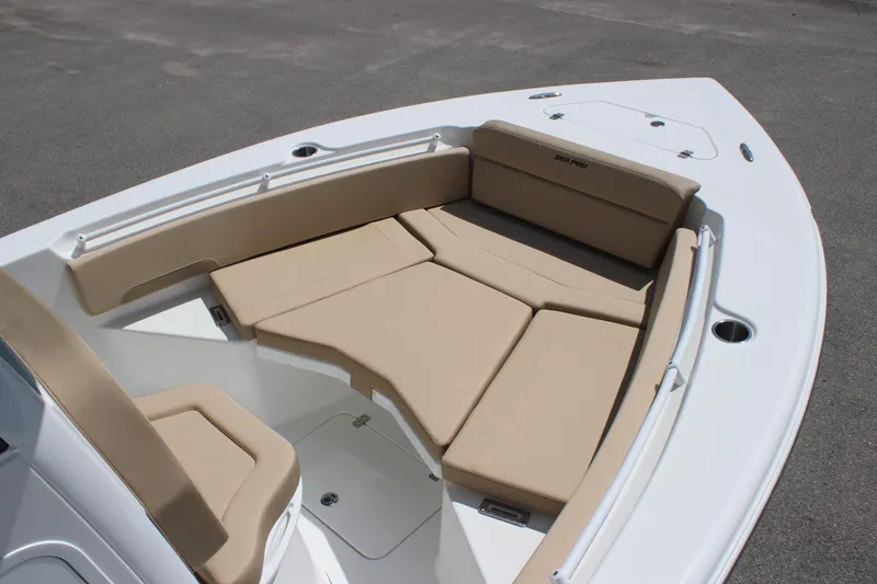 Slide: The Image of 2026 Sea Pro 245 Sandbar boat with beige cushioned seating and sleek white deck. - 28
