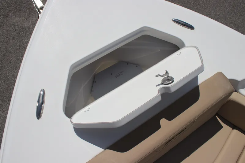 Slide: The Image of Storage compartment on 2026 Sea Pro 245 Sandbar boat, featuring a secure latch and beige seating. - 30