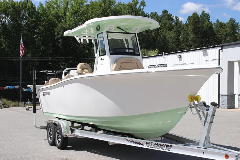 Slide: The Image of 2026 Sea Pro 245 Sandbar boat on trailer, outdoors, sunny day. - 33