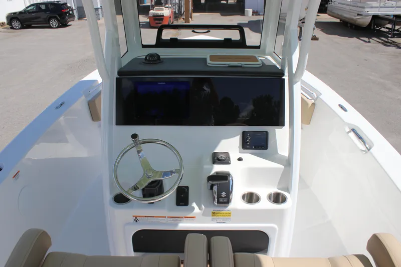 Slide: The Image of 2026 Sea Pro 245 Sandbar boat helm with steering wheel, controls, and display screen. - 37