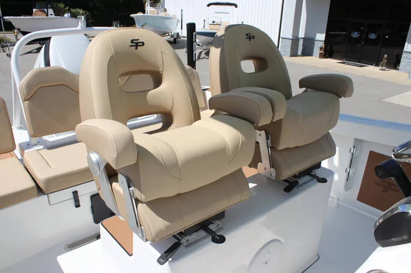 Slide: The Image of 2026 Sea Pro 245 Sandbar boat with beige captain chairs and armrests. - 40