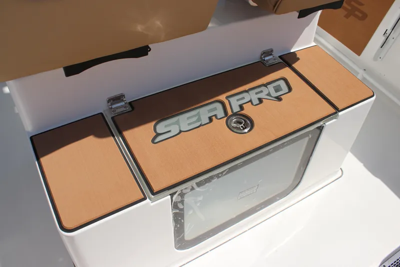 Slide: The Image of 2026 Sea Pro 245 Sandbar boat console with storage compartment and logo. - 44