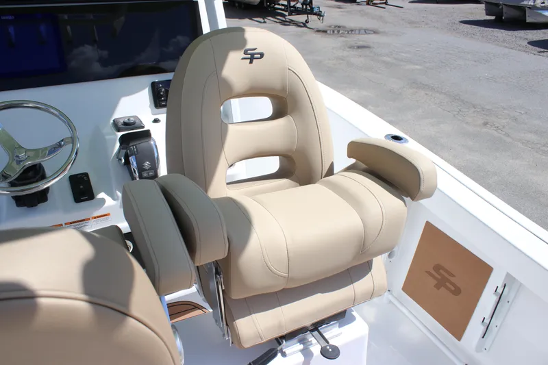 Slide: The Image of Luxurious captain's chair on 2026 Sea Pro 245 Sandbar boat, featuring beige upholstery and ergonomic design. - 48