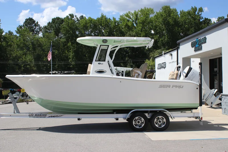 Slide: The Image of 2026 Sea Pro 245 Sandbar boat on trailer, parked outside marine dealership. - 7