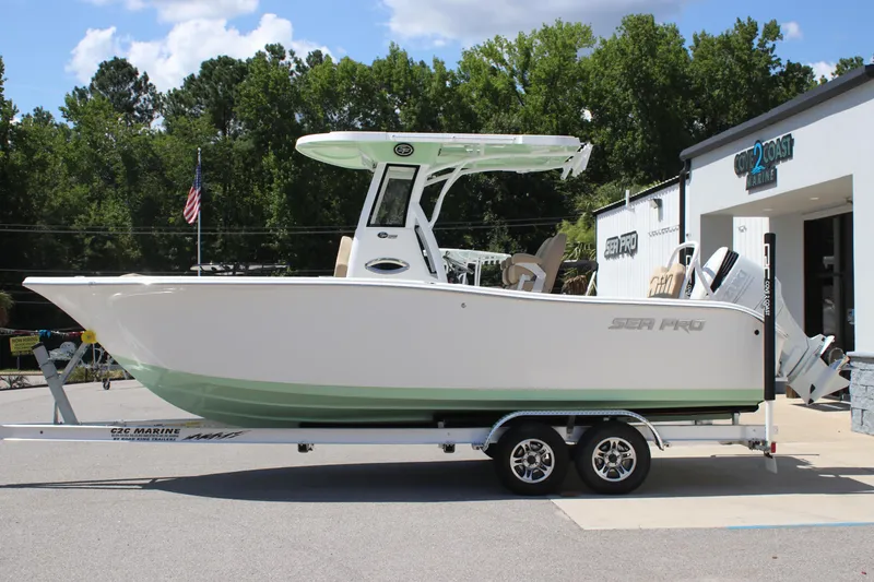 Slide: The Image of 2026 Sea Pro 245 Sandbar boat on trailer, parked outside marine dealership. - 8