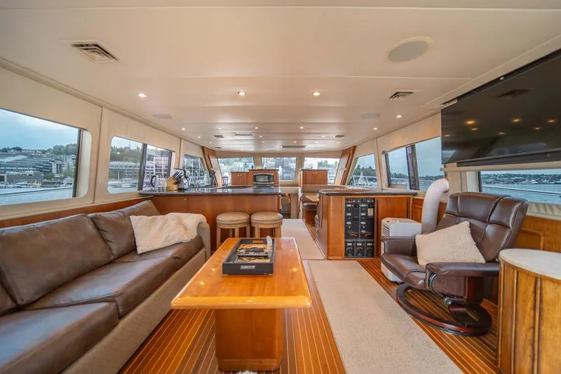 Slide: The Image of Luxurious interior of 1988 Hatteras 65 Sportfish yacht with leather seating and panoramic windows. - 10