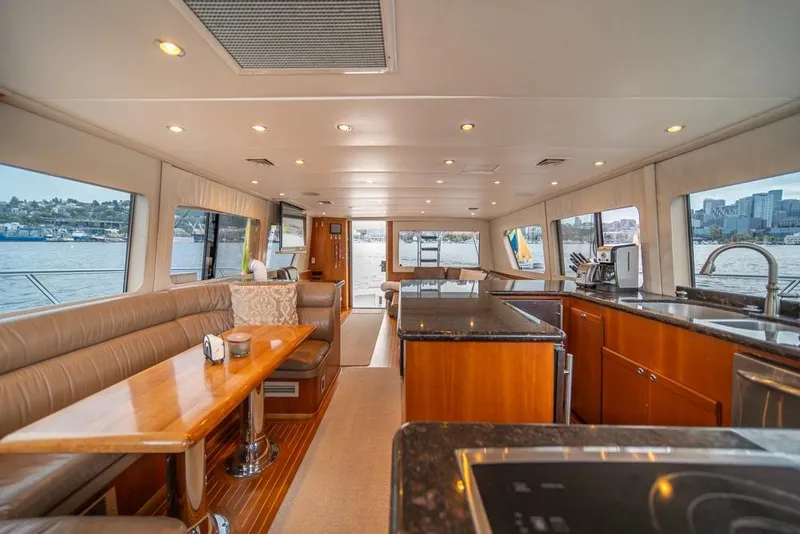 Slide: The Image of Luxurious interior of 1988 Hatteras 65 Sportfish yacht with modern kitchen and seating area. - 11