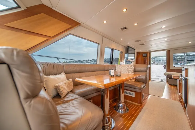 Slide: The Image of Luxurious interior of 1988 Hatteras 65 Sportfish yacht with leather seating and wooden accents. - 12