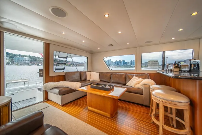 Slide: The Image of Luxurious interior of 1988 Hatteras 65 Sportfish yacht with city skyline view. - 13