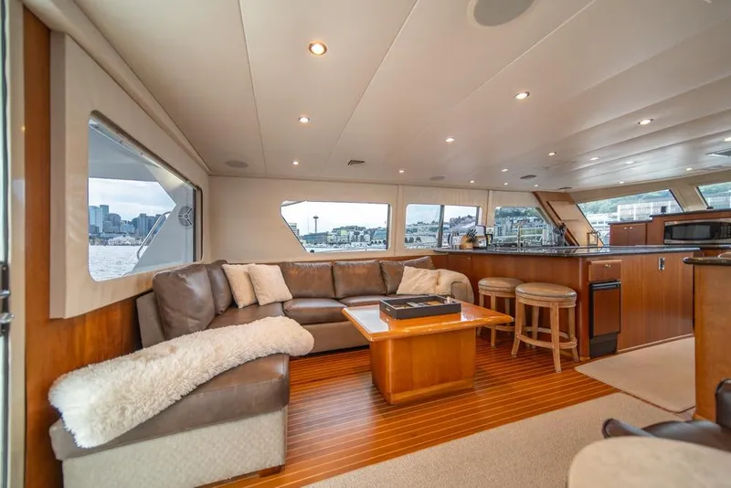 Slide: The Image of Luxurious interior of 1988 Hatteras 65 Sportfish yacht with plush seating and panoramic windows. - 14