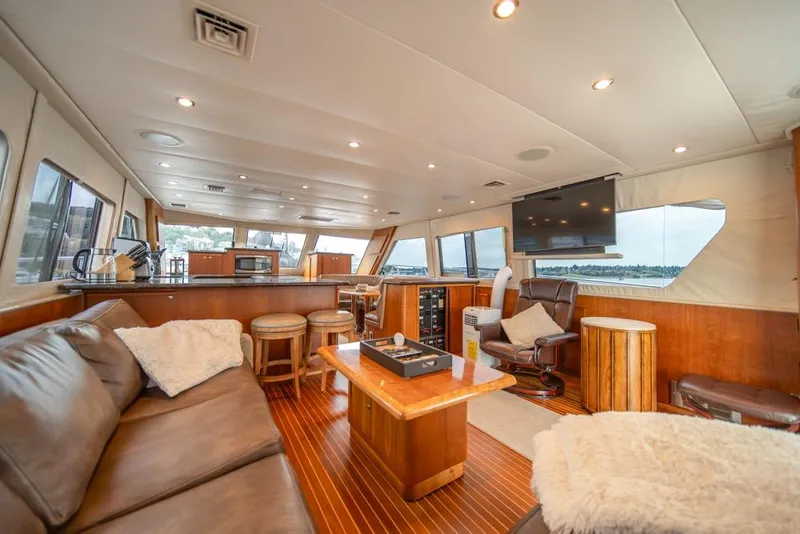Slide: The Image of Luxurious interior of 1988 Hatteras 65 Sportfish yacht with leather seating and modern amenities. - 15