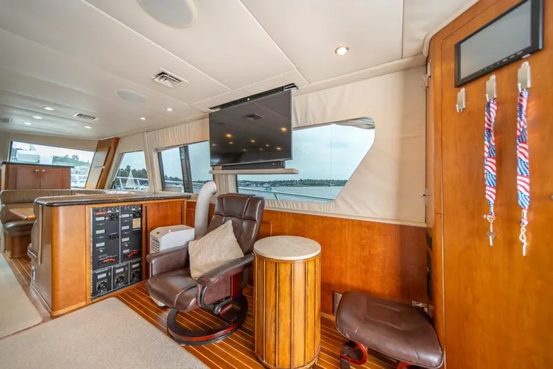 Slide: The Image of Luxurious interior of 1988 Hatteras 65 Sportfish yacht with leather seating and wood accents. - 16
