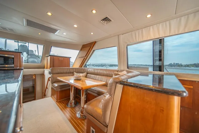 Slide: The Image of Luxurious interior of 1988 Hatteras 65 Sportfish yacht with panoramic windows and elegant seating. - 20