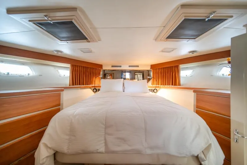 Slide: The Image of Luxurious cabin interior of 1988 Hatteras 65 Sportfish yacht with cozy bedding. - 22