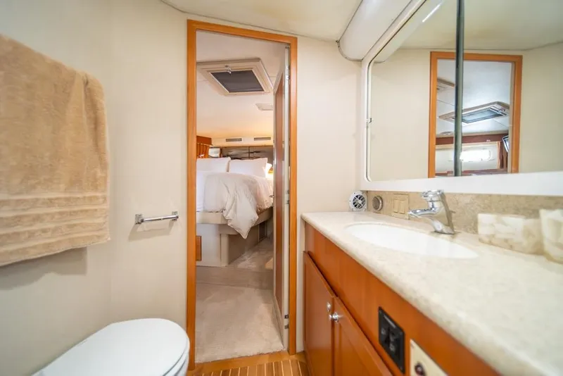Slide: The Image of Bathroom interior of 1988 Hatteras 65 Sportfish yacht, featuring sink and mirror. - 24