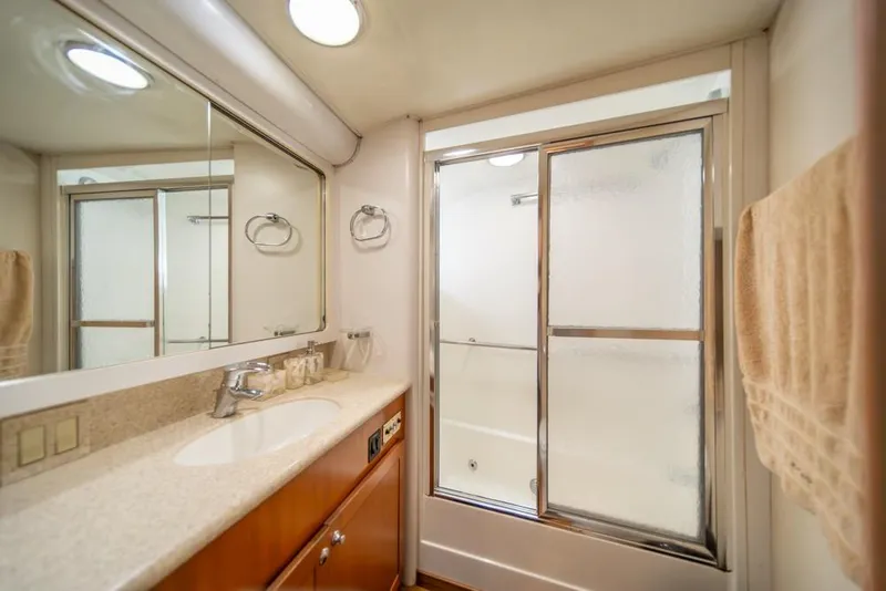Slide: The Image of Luxurious bathroom in 1988 Hatteras 65 Sportfish yacht with shower and vanity. - 25