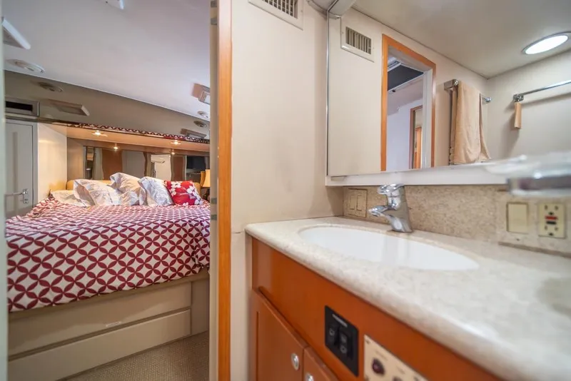 Slide: The Image of Interior of 1988 Hatteras 65 Sportfish yacht with cozy bedroom and bathroom. - 30