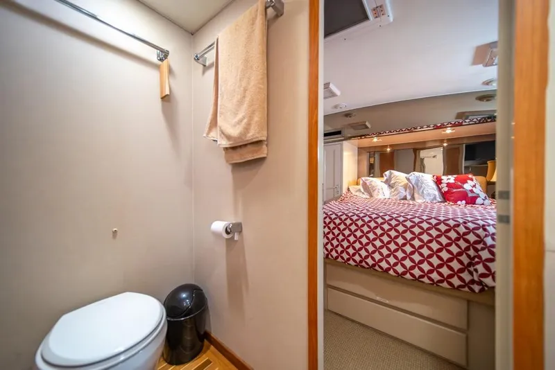 Slide: The Image of Bathroom and bedroom interior of 1988 Hatteras 65 Sportfish yacht, featuring modern amenities. - 31