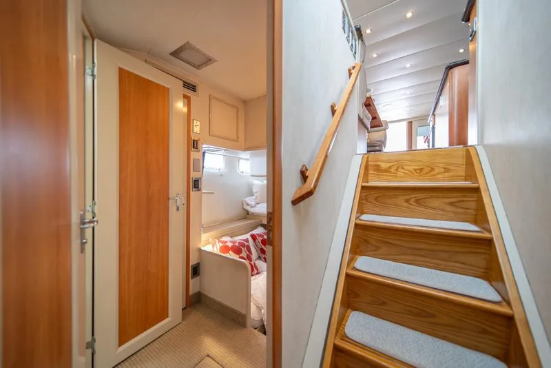 Slide: The Image of Interior of 1988 Hatteras 65 Sportfish yacht with wooden stairs and cozy cabin. - 33