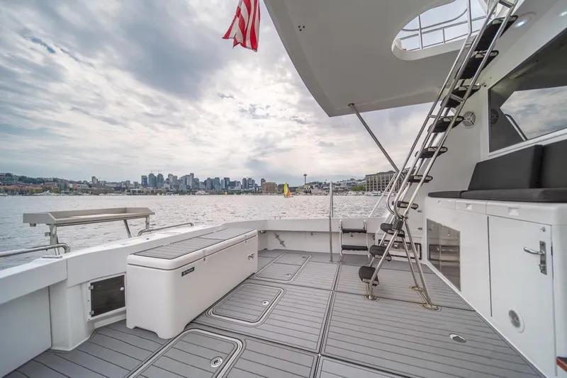 Slide: The Image of 1988 Hatteras 65 Sportfish yacht deck with city skyline view. - 39