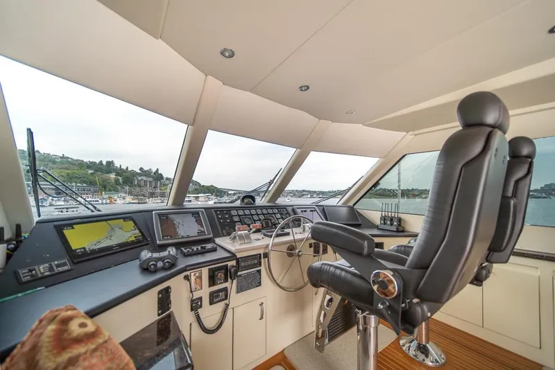 Slide: The Image of Helm of 1988 Hatteras 65 Sportfish yacht with navigation equipment and captain's chair. - 43
