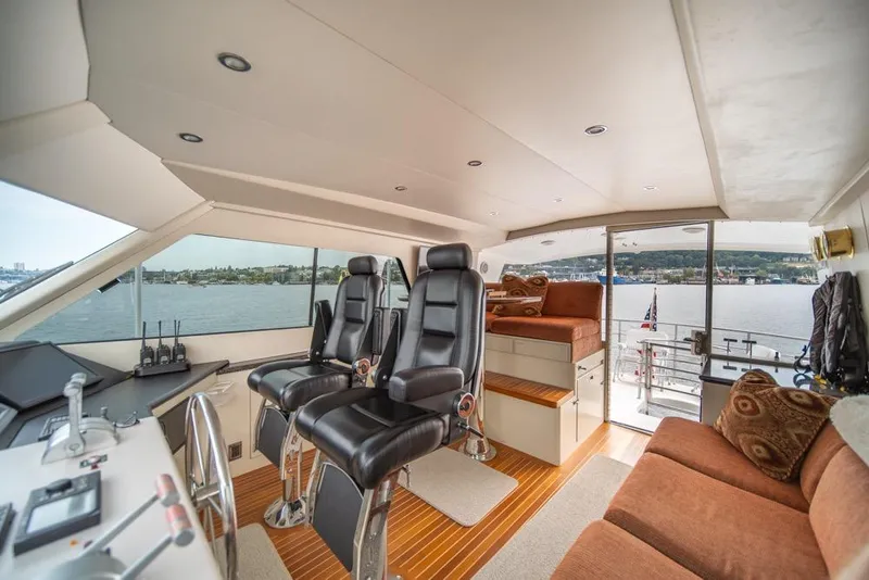 Slide: The Image of Interior of 1988 Hatteras 65 Sportfish yacht with leather seats and panoramic windows. - 44