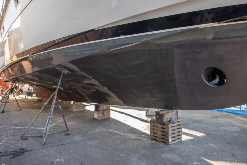 Slide: The Image of 1988 Hatteras 65 Sportfish yacht on dry dock, hull maintenance underway. - 53