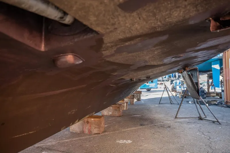 Slide: The Image of Underside view of 1988 Hatteras 65 Sportfish boat on dry dock. - 55